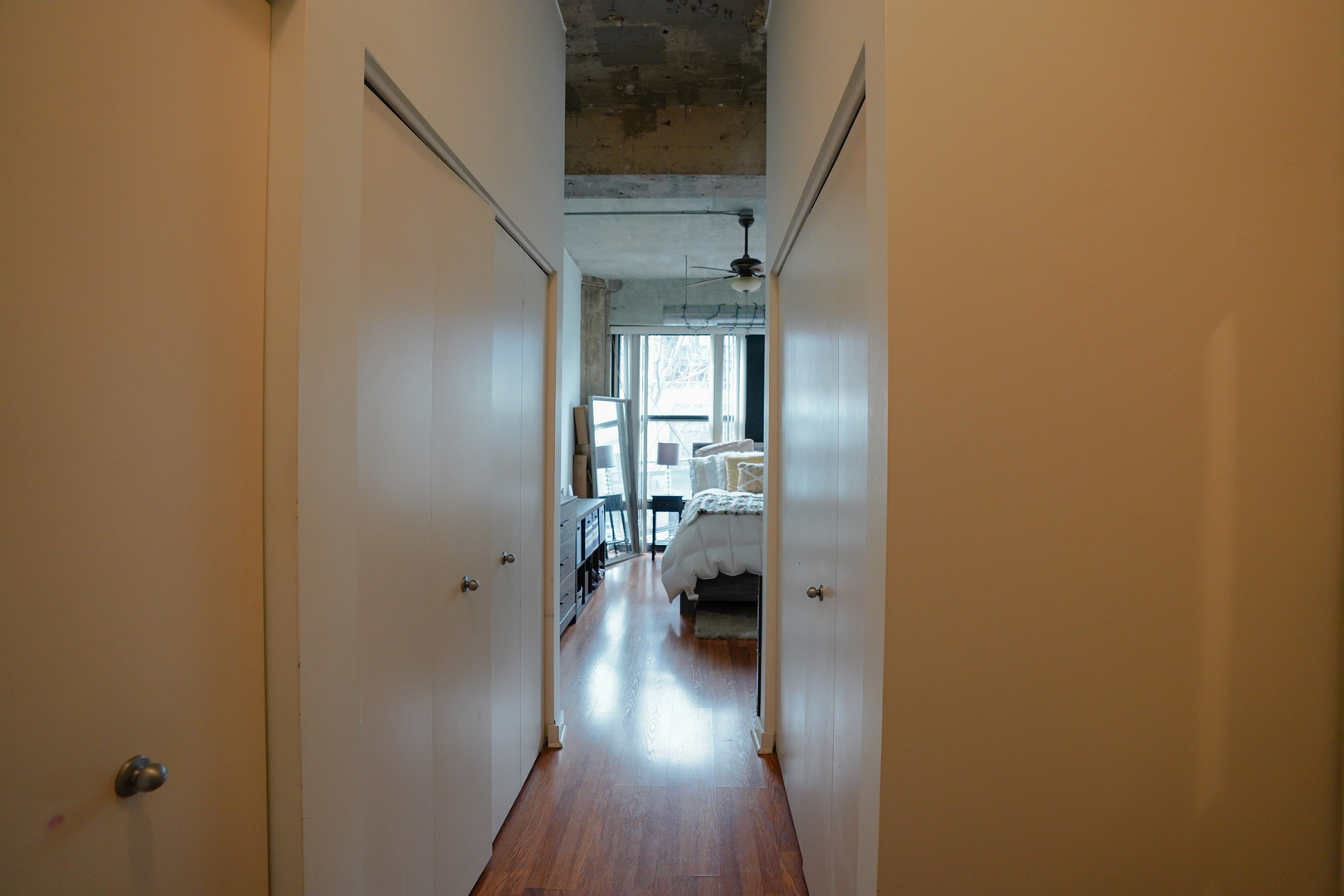 1069 West 14th Place, Unit 303 Chicago, IL 60608 - Photo 12 of 26 a view of a hallway with wooden floor fireplace and living room