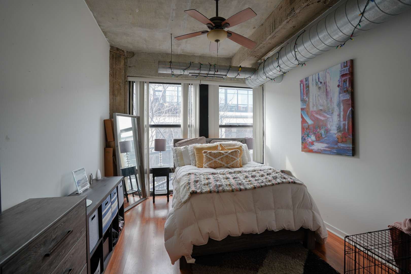 1069 West 14th Place, Unit 303 Chicago, IL 60608 - Photo 13 of 26 a bedroom with a bed and a table
