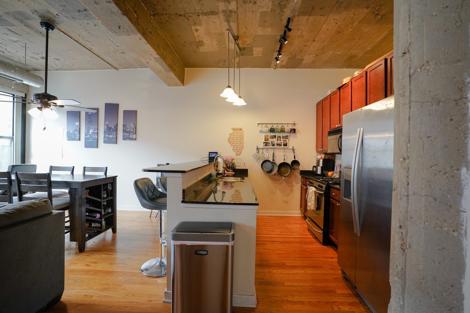 1069 West 14th Place, Unit 303 Chicago, IL 60608 - Photo 2 of 26 a kitchen with stainless steel appliances granite countertop a refrigerator a stove and a sink with dishwasher
