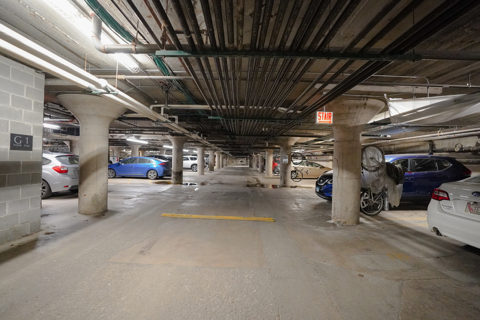 1069 West 14th Place, Unit 303 Chicago, IL 60608 - Photo 22 of 26 a view of parking garage with cars