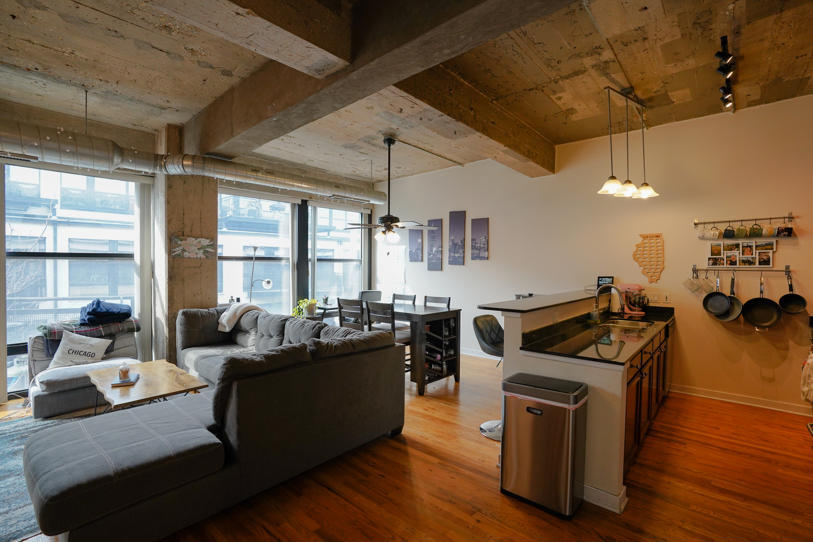 1069 West 14th Place, Unit 303 Chicago, IL 60608 - Photo 6 of 26 a living room with furniture and a flat screen tv