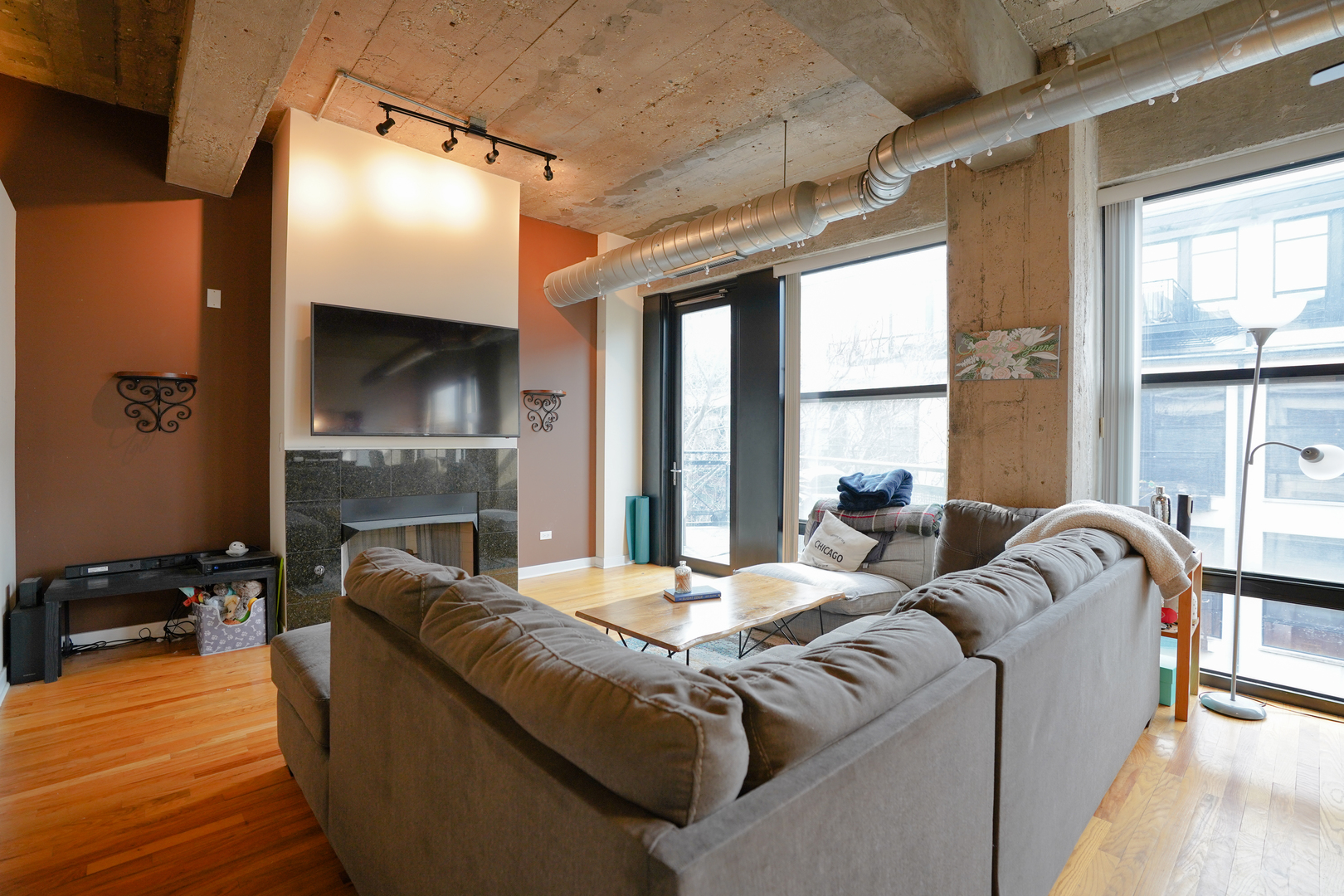 1069 West 14th Place, Unit 303 Chicago, IL 60608 - Photo 7 of 26 a living room with furniture and a fireplace