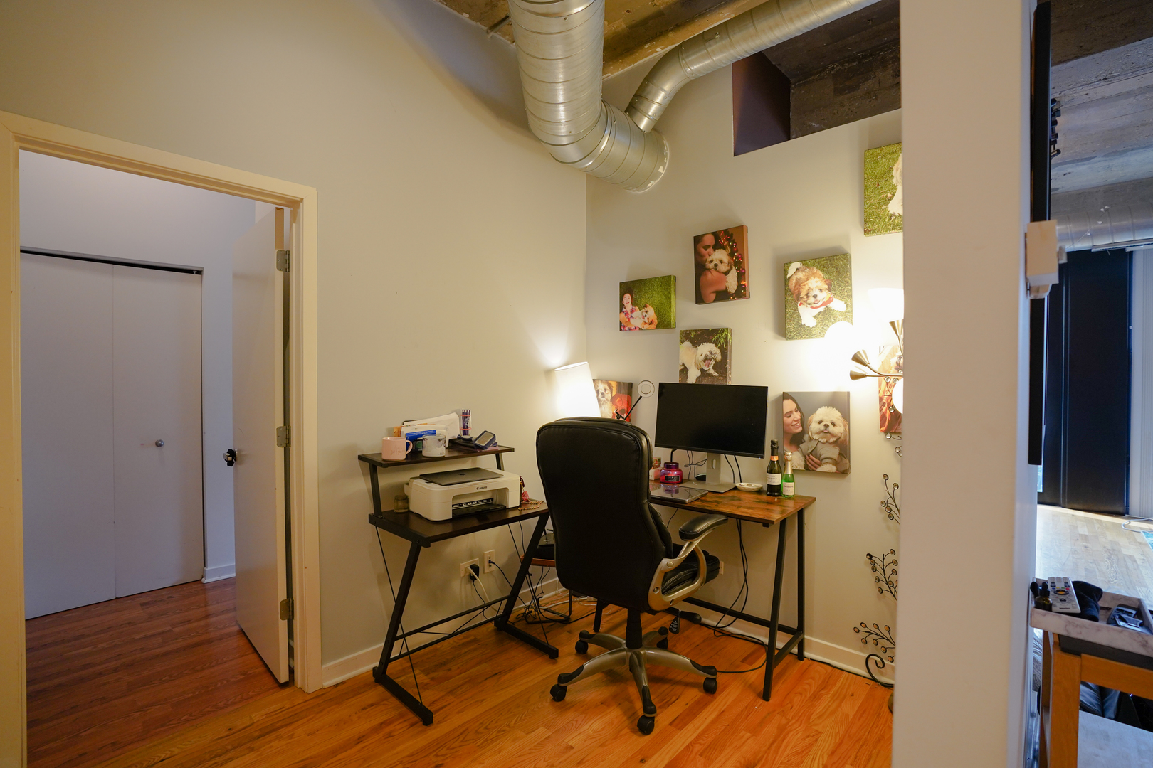 1069 West 14th Place, Unit 303 Chicago, IL 60608 - Photo 8 of 26 a view of a workspace with furniture and wooden floor
