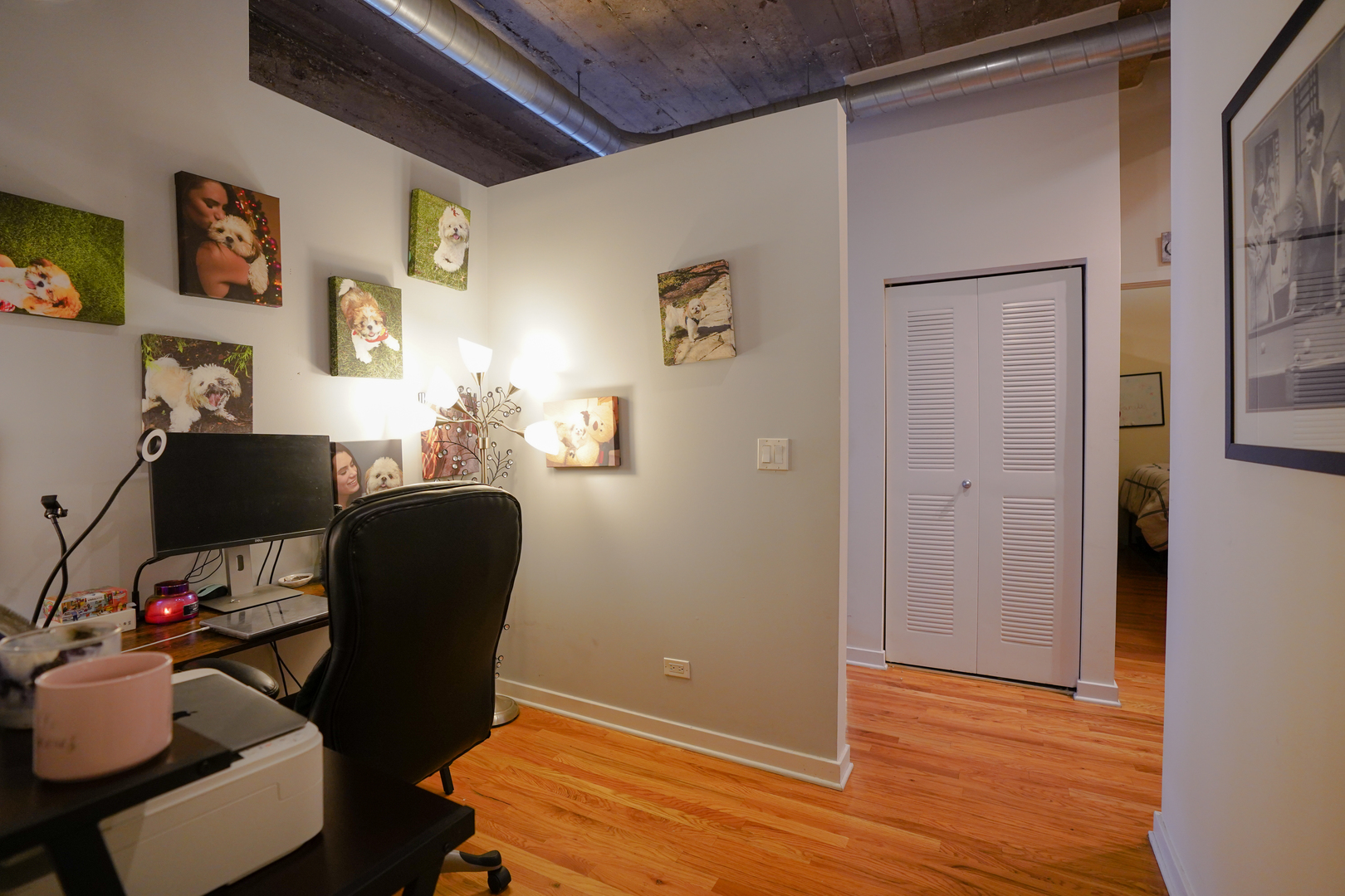 1069 West 14th Place, Unit 303 Chicago, IL 60608 - Photo 9 of 26 a workspace with wooden floor and furniture