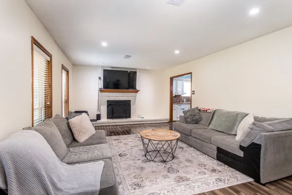 a living room with furniture a flat screen tv and a fireplace