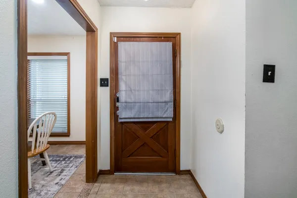 a view of a door and chair in a room