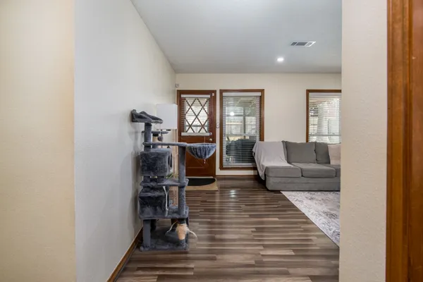 a living room with furniture and wooden floor