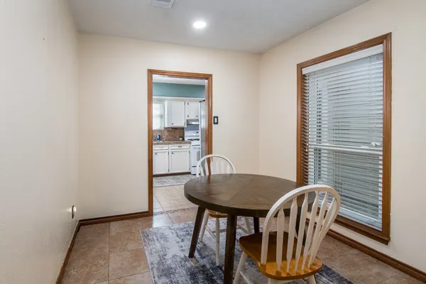 a dining room with furniture and window