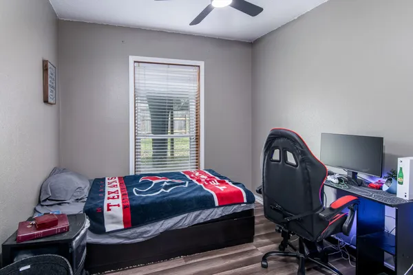 a bedroom with a bed and wooden floor