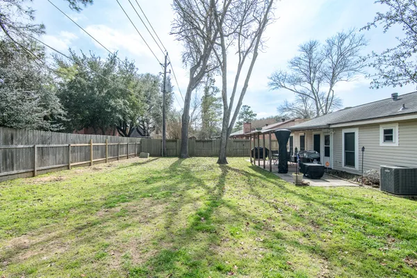 a view of a house with a yard patio and fire pit