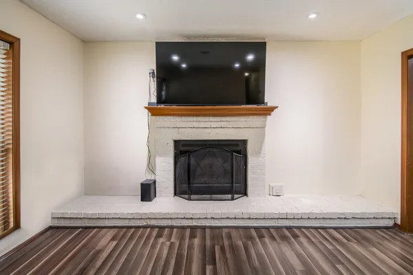 a living room with a fireplace and a rug