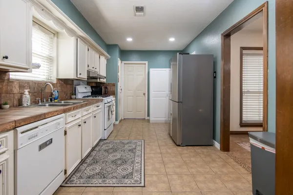 a kitchen with a refrigerator and a sink