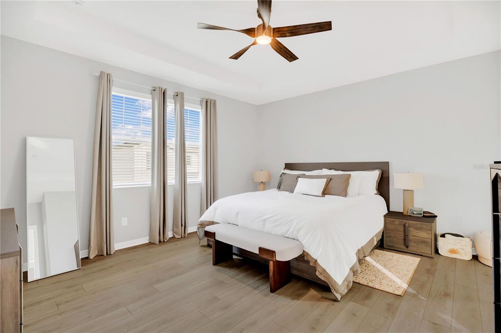 635 Cheval Lane DeBary, FL 32713 - Photo 14 of 33 a spacious bedroom with a bed and large window