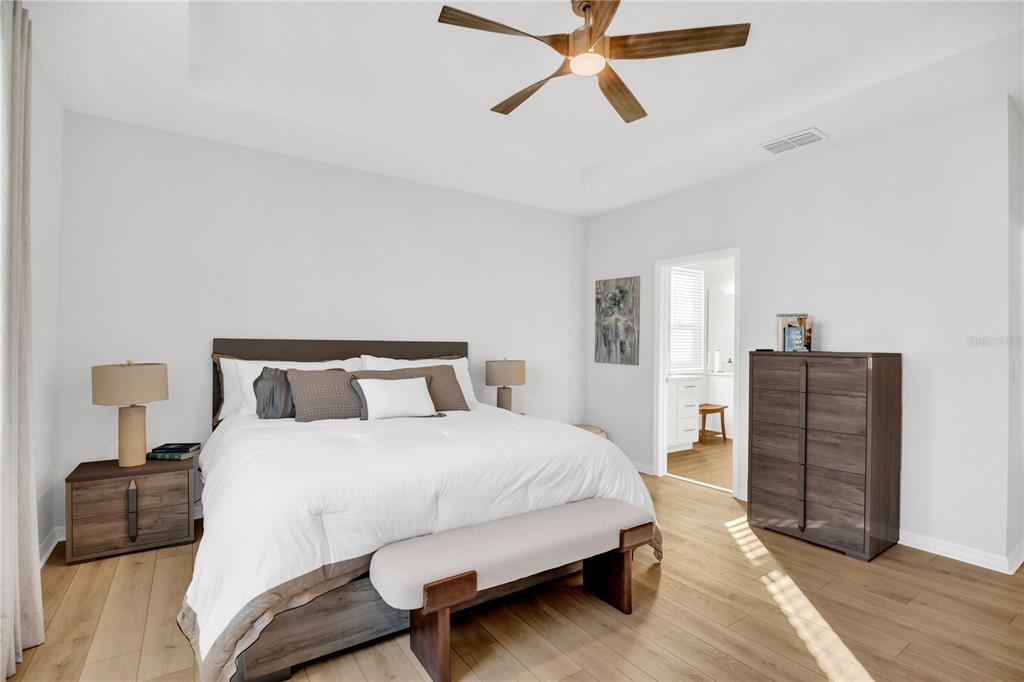 635 Cheval Lane DeBary, FL 32713 - Photo 15 of 33 a bedroom with a bed and wooden floor