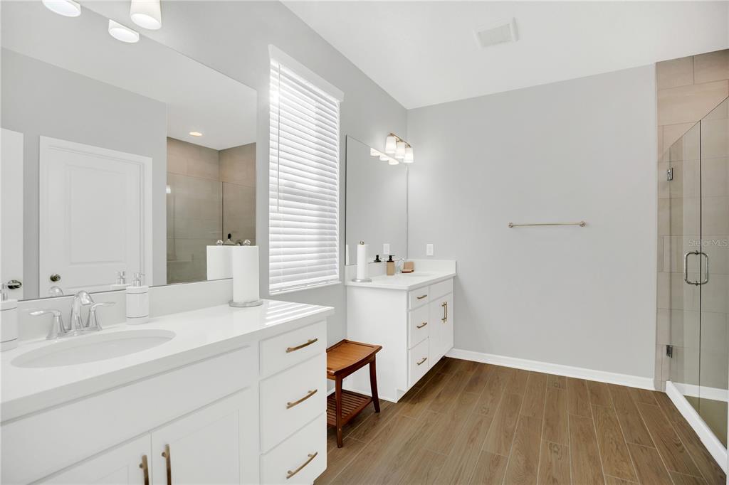 635 Cheval Lane DeBary, FL 32713 - Photo 17 of 33 a bathroom with double vanity sink a mirror and a shower