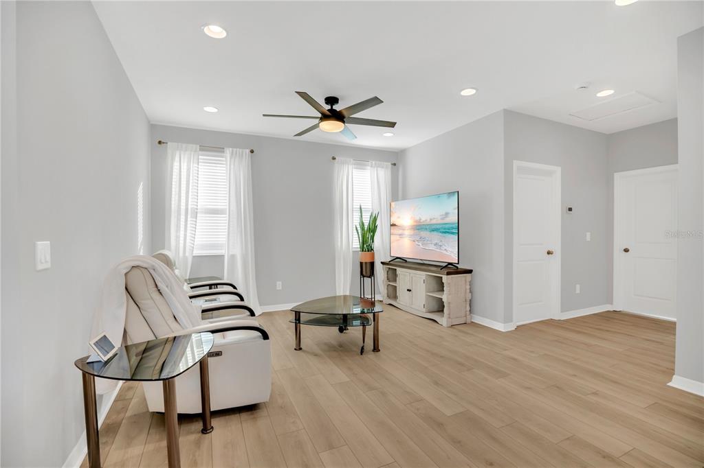 635 Cheval Lane DeBary, FL 32713 - Photo 20 of 33 a living room with furniture and a flat screen tv with wooden floor