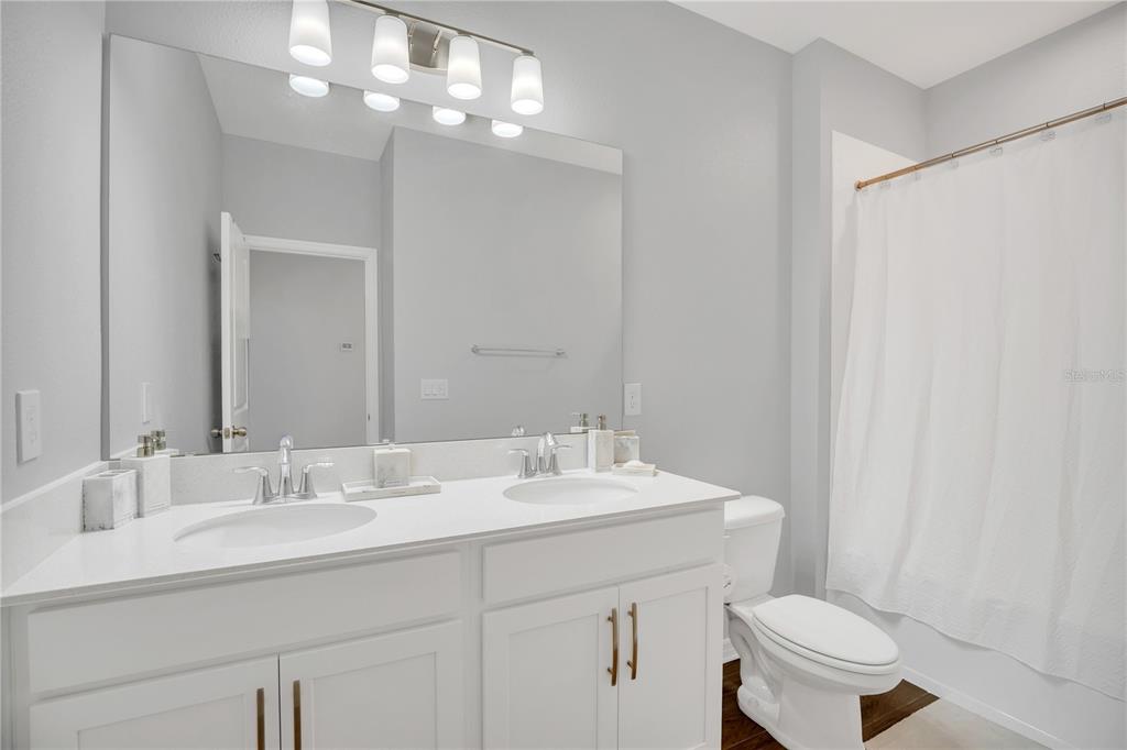 635 Cheval Lane DeBary, FL 32713 - Photo 24 of 33 a bathroom with a sink toilet and a mirror