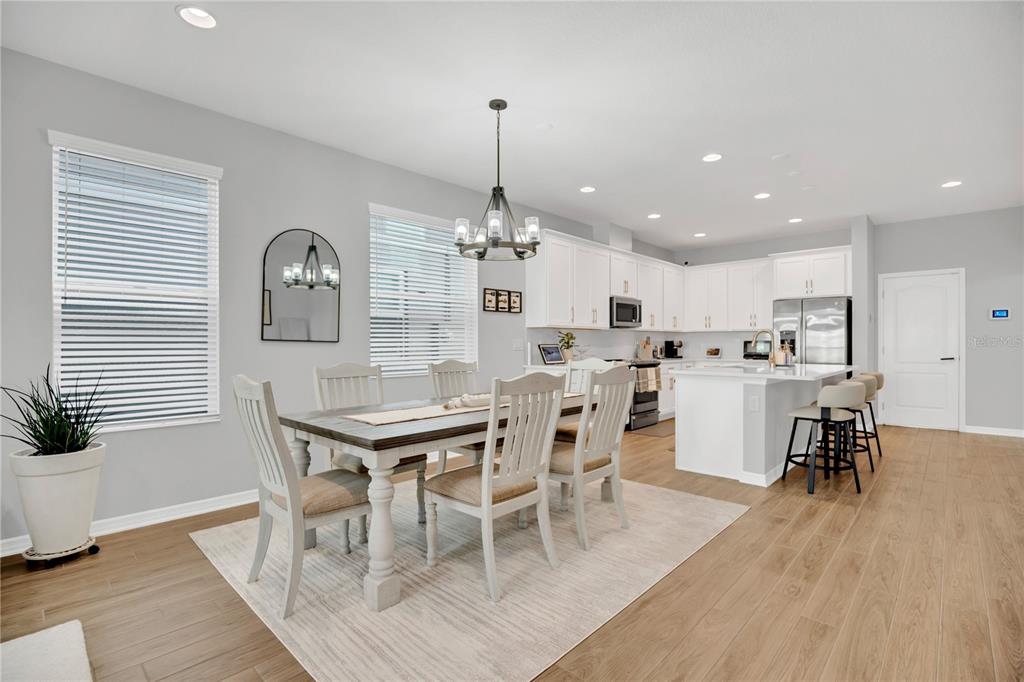 635 Cheval Lane DeBary, FL 32713 - Photo 7 of 33 a dining room with furniture a chandelier and wooden floor