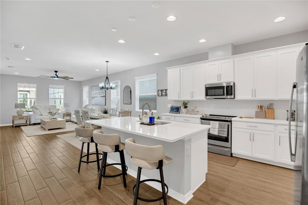 635 Cheval Lane DeBary, FL 32713 - Photo 9 of 33 a kitchen with counter top space a sink appliances and cabinets