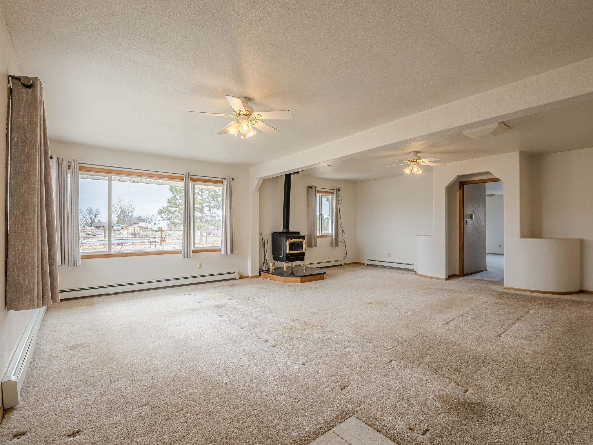 1895 L Road Fruita, CO 81521 - Photo 11 of 29 an empty room with chandelier fan and windows
