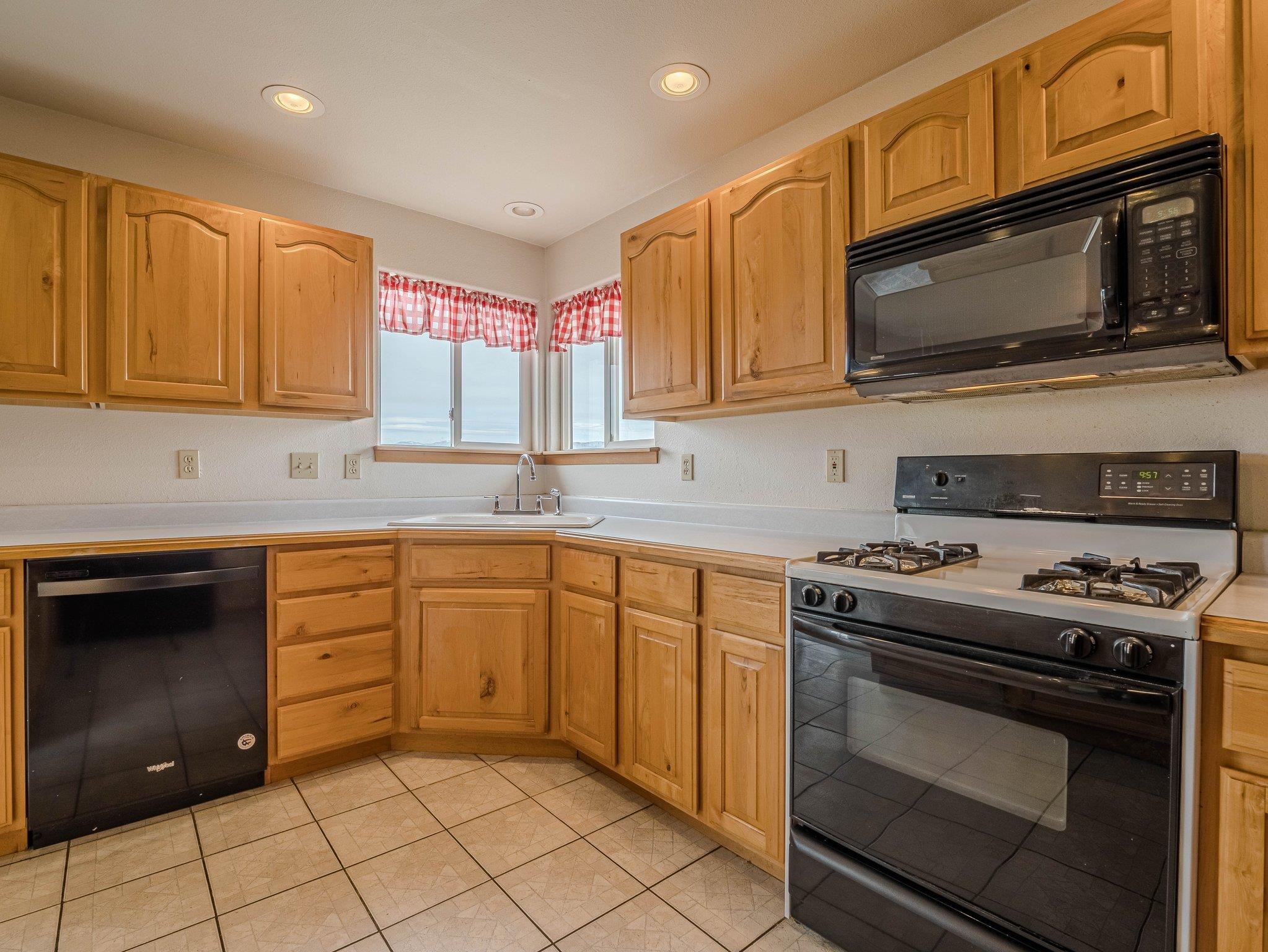 1895 L Road Fruita, CO 81521 - Photo 19 of 29 a kitchen with stainless steel appliances granite countertop a stove microwave and sink