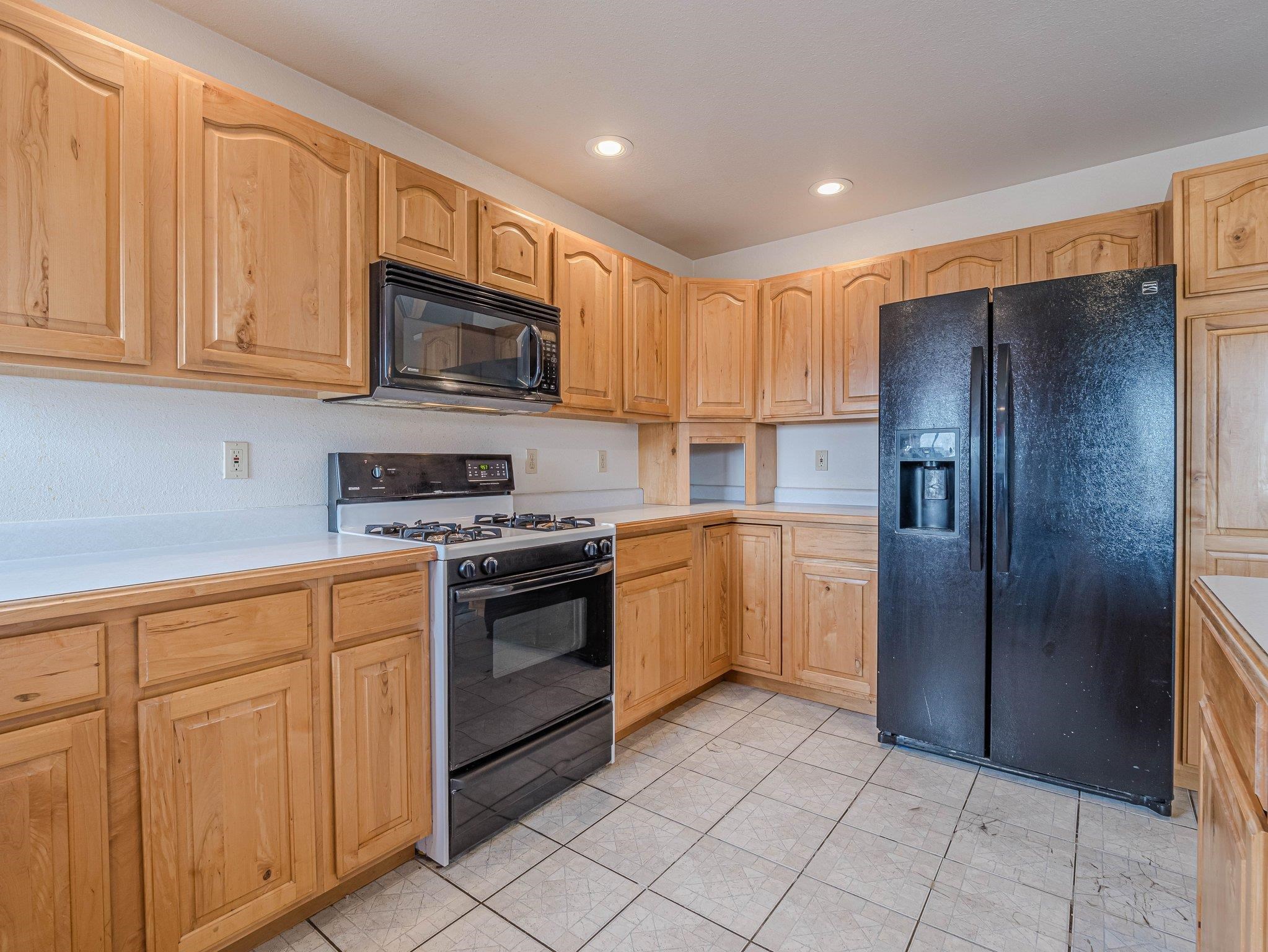 1895 L Road Fruita, CO 81521 - Photo 20 of 29 a kitchen with stainless steel appliances granite countertop a refrigerator and a stove top oven