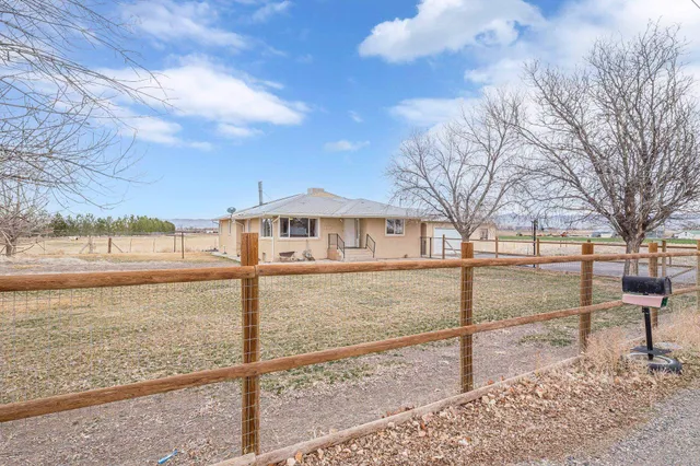 a view of a yard with wooden fence