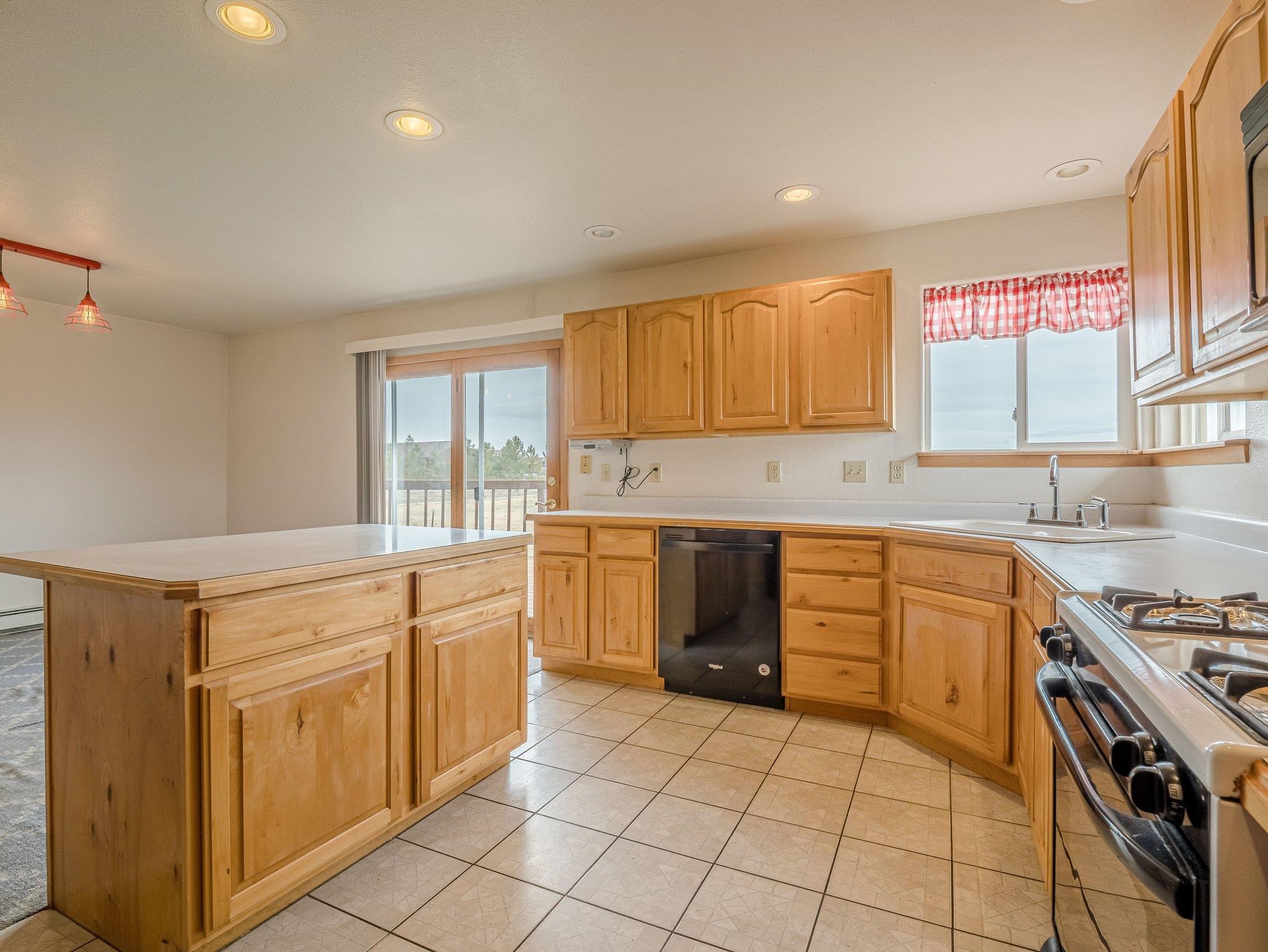 1895 L Road Fruita, CO 81521 - Photo 21 of 29 a kitchen with a stove top oven sink and cabinets