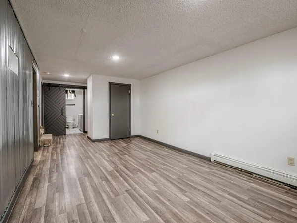 a view of an empty room and wooden floor