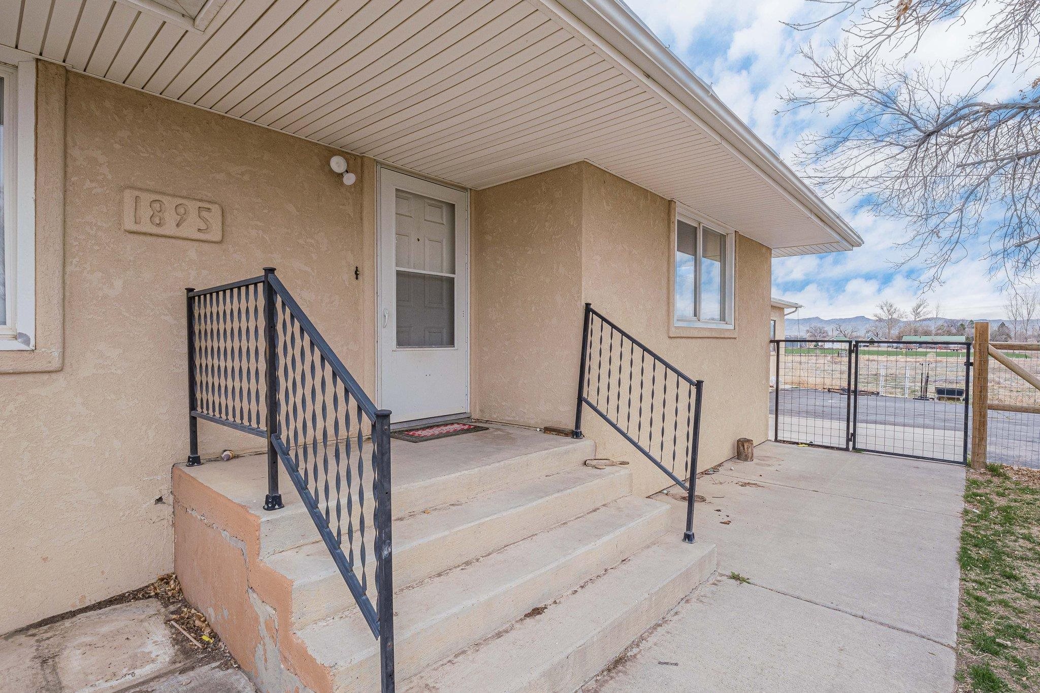 1895 L Road Fruita, CO 81521 - Photo 8 of 29 a view of staircase with railing and white walls