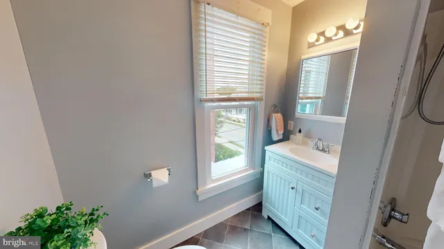 a room with a window a sink and a mirror