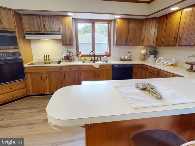 a kitchen with stainless steel appliances sink refrigerator and window