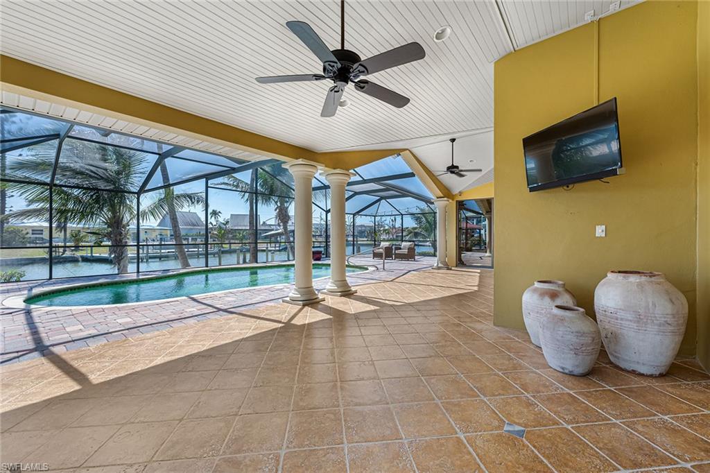 390 Randy Lane Fort Myers Beach, FL 33931 - Photo 12 of 19 a living room with couches a flat screen tv and kitchen view