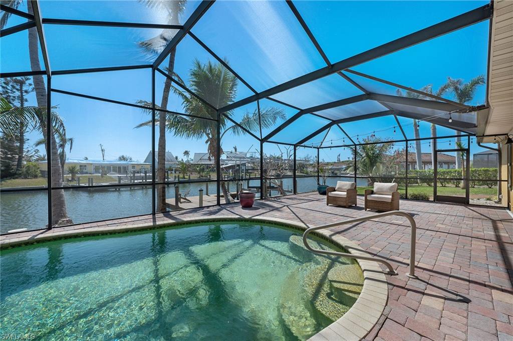 390 Randy Lane Fort Myers Beach, FL 33931 - Photo 15 of 19 a view of a backyard with a deck and dining area