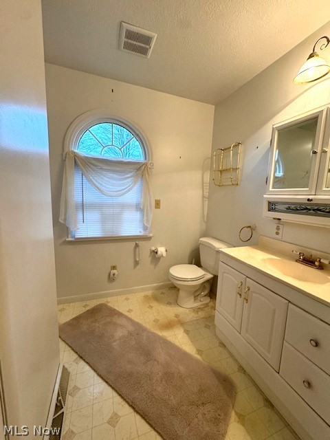 2036 Salt Springs Road Warren, OH 44481 - Photo 12 of 23 Bathroom with a textured ceiling, vanity, tile floors, and toilet