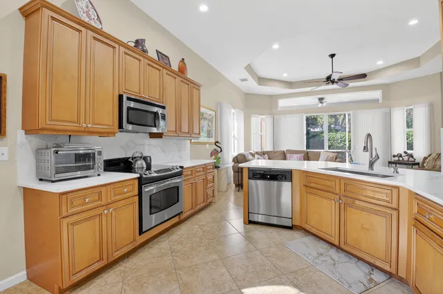 a bathroom with a granite countertop sink mirror and toilet
