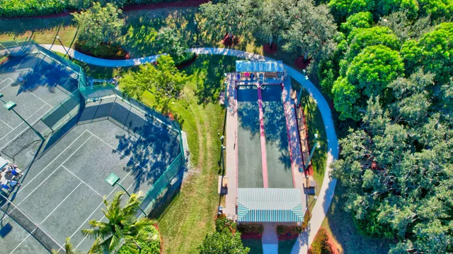 a view of a swimming pool with a table and chairs under an umbrella