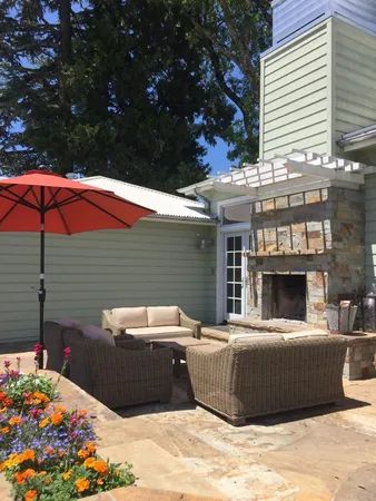 a view of a patio with table and chairs under an umbrella