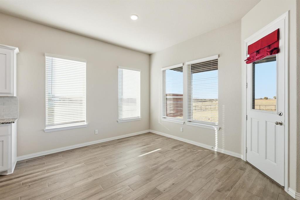 139 Steppes Court Decatur, TX 76234 - Photo 26 of 40 an empty room with wooden floor and windows