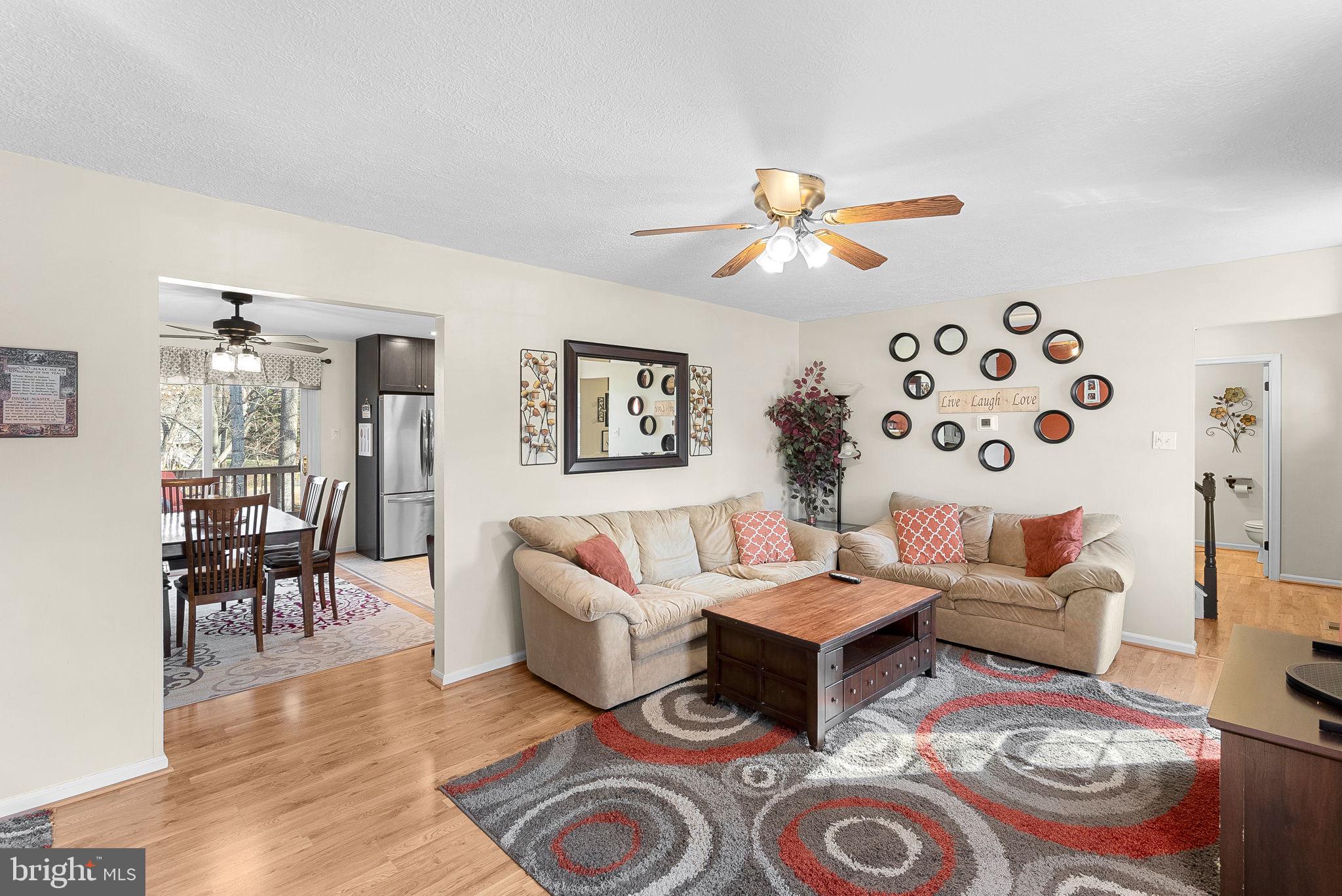 6130 Windward Drive Burke, VA 22015 - Photo 12 of 50 a living room with furniture a rug and a chandelier