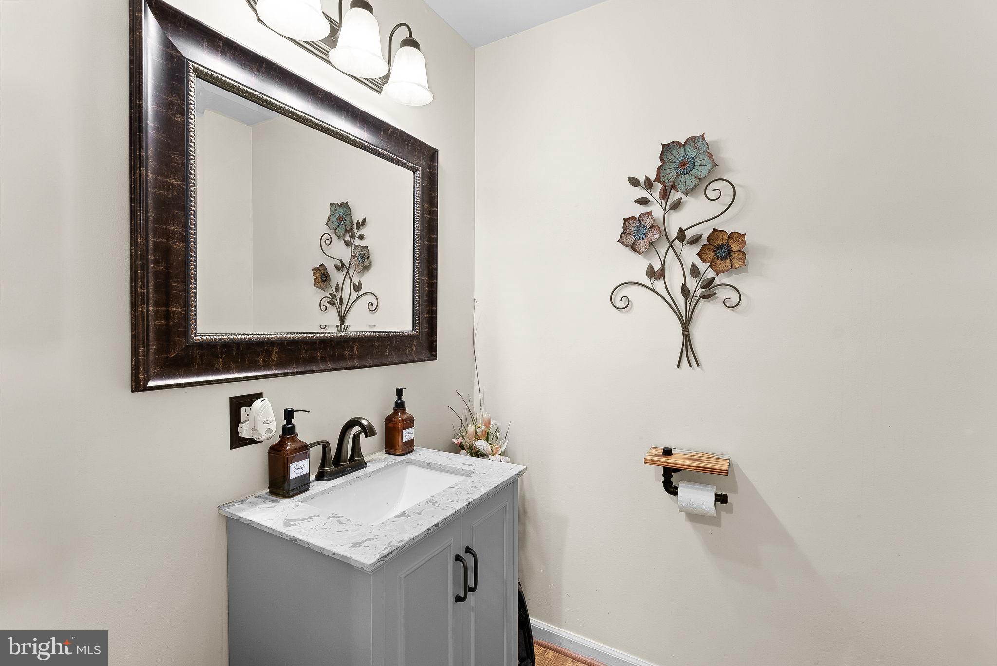 6130 Windward Drive Burke, VA 22015 - Photo 19 of 50 a bathroom with a sink and a mirror