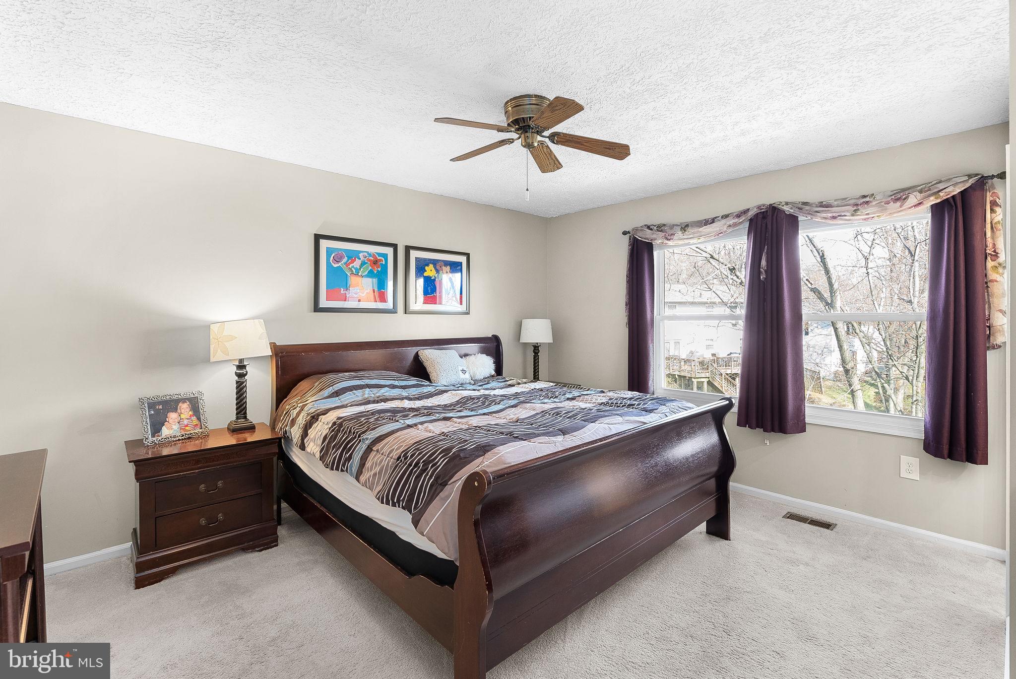 6130 Windward Drive Burke, VA 22015 - Photo 21 of 50 a spacious bedroom with a bed and a large window