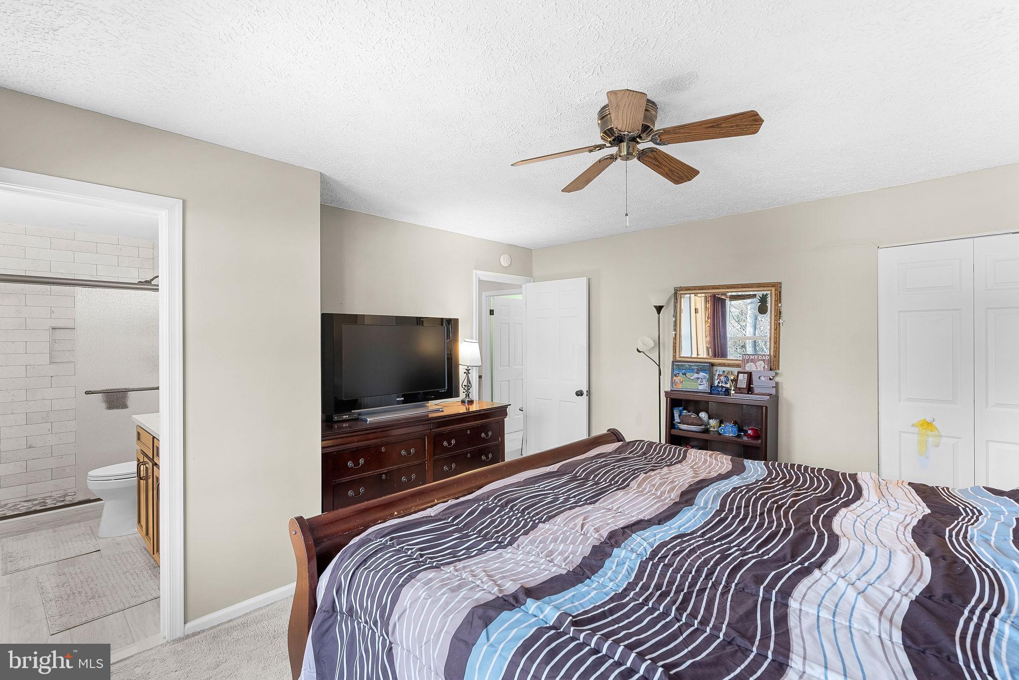 6130 Windward Drive Burke, VA 22015 - Photo 22 of 50 a bedroom with a bed and a flat screen tv