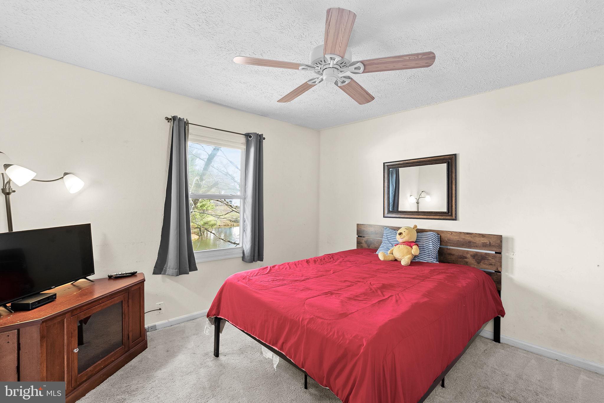 6130 Windward Drive Burke, VA 22015 - Photo 26 of 50 a bedroom with a bed and a flat screen tv