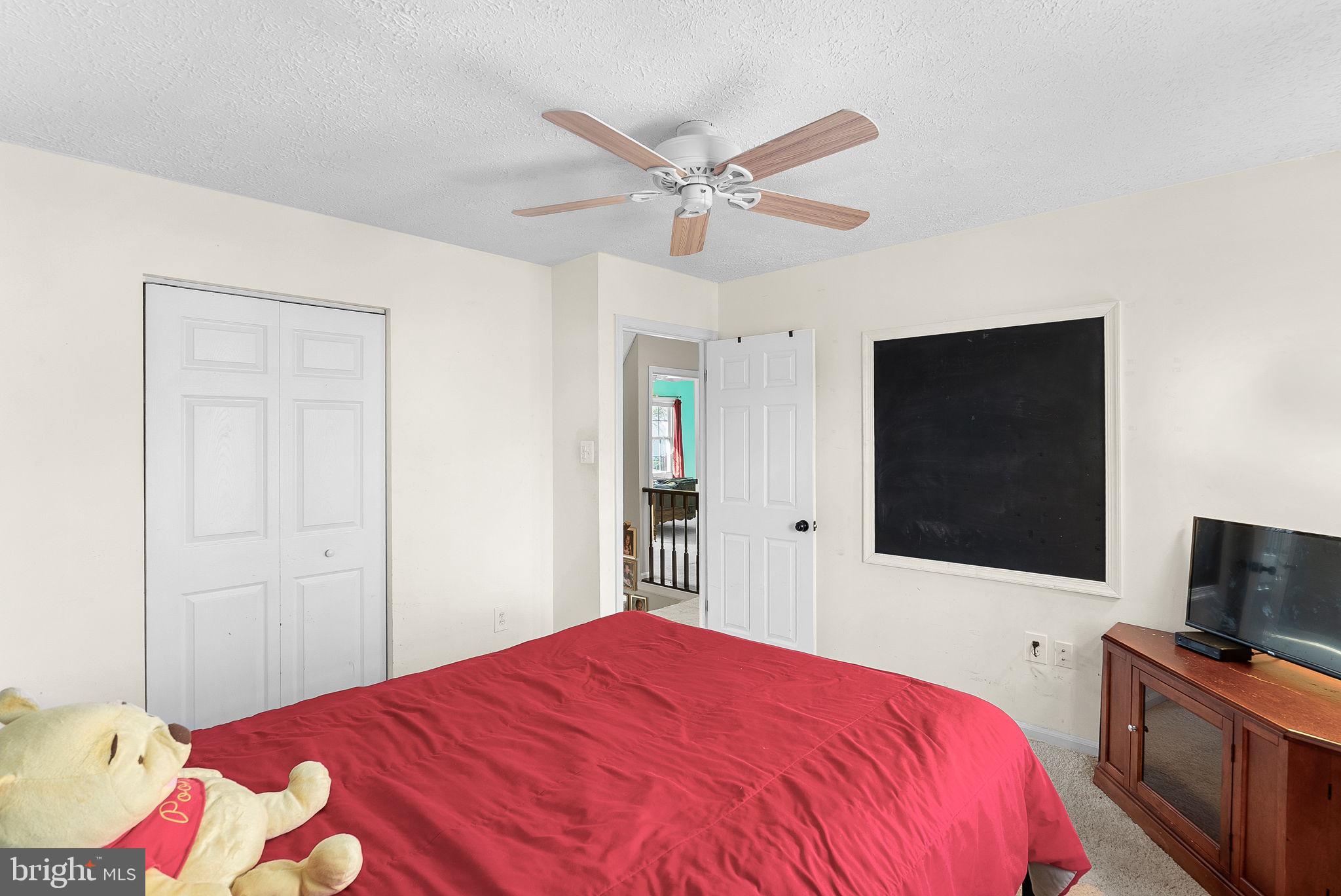 6130 Windward Drive Burke, VA 22015 - Photo 27 of 50 a bedroom with a bed and a flat screen tv