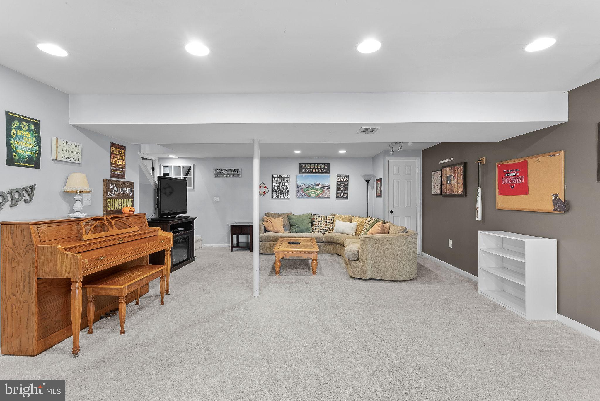 6130 Windward Drive Burke, VA 22015 - Photo 35 of 50 a living room with furniture and a flat screen tv