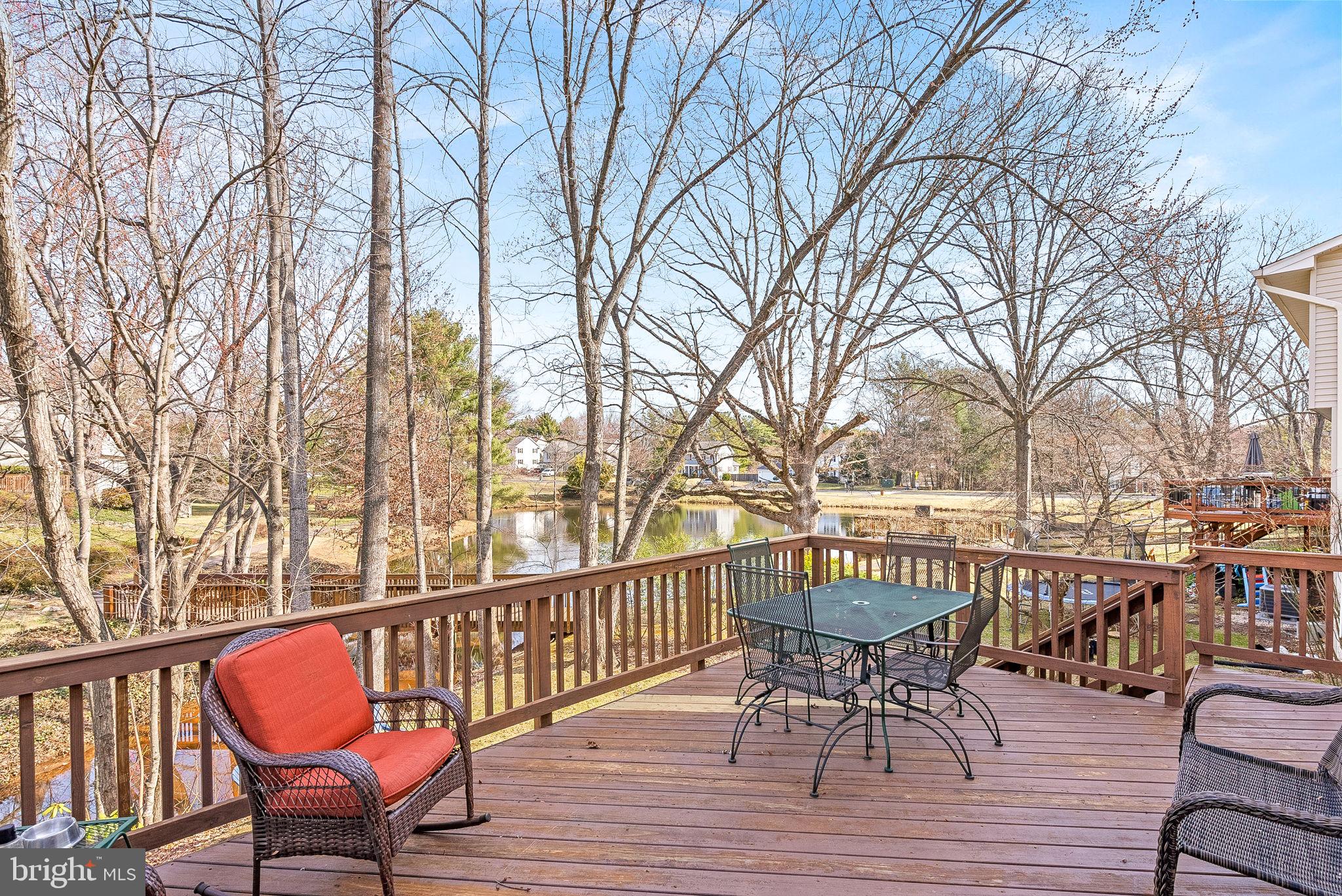 6130 Windward Drive Burke, VA 22015 - Photo 39 of 50 a view of a chair and table on the roof deck with wooden floor and fence