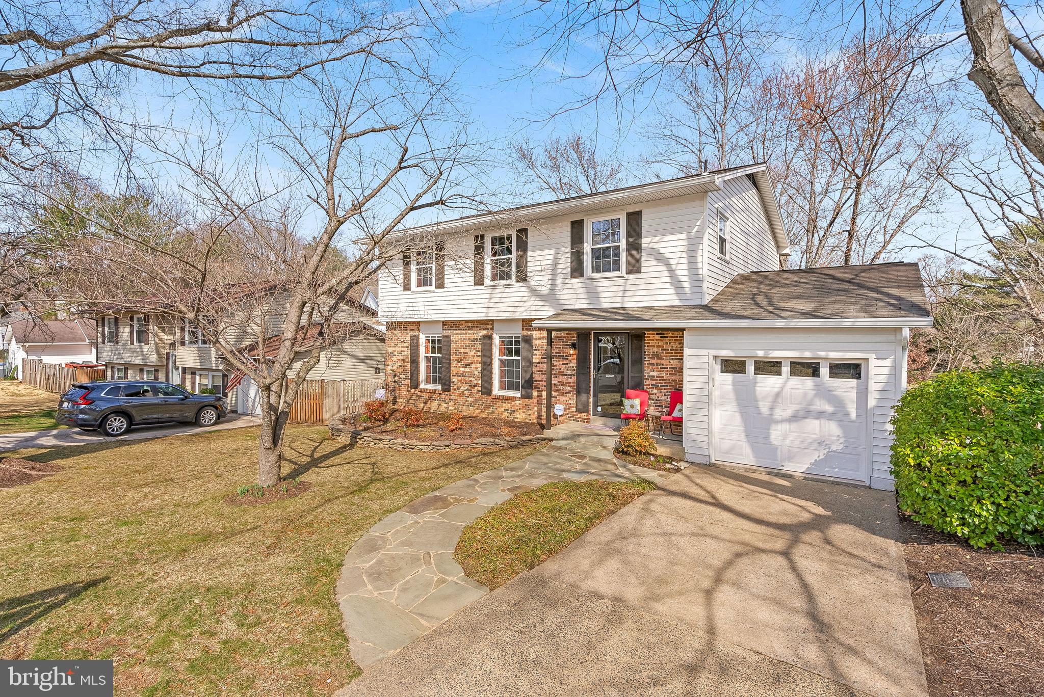 6130 Windward Drive Burke, VA 22015 - Photo 50 of 50 a view of a white house with a yard and sitting area