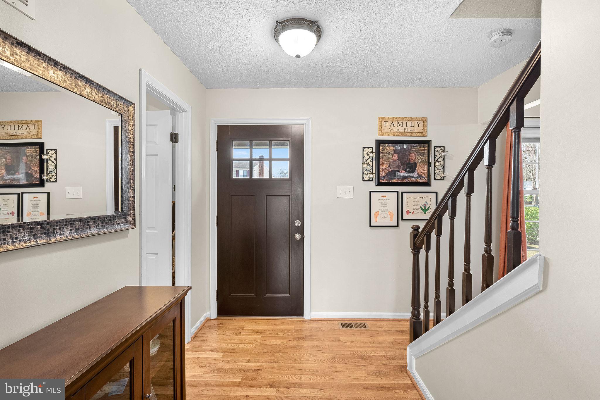 6130 Windward Drive Burke, VA 22015 - Photo 7 of 50 a view of a hallway with wooden floor and staircase