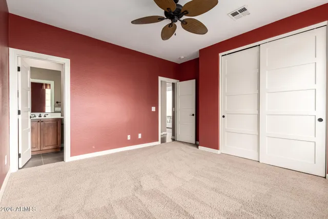 a view of a bedroom with closet and windows